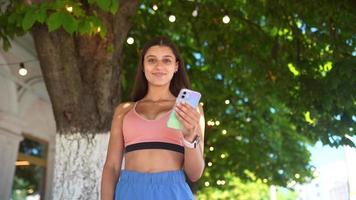 Girl in the park with smartphone video