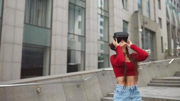 Girl in virtual reality glasses outdoors video