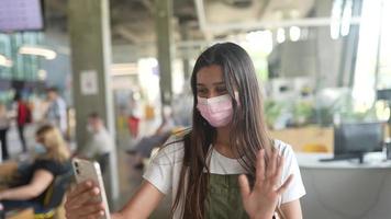 Woman wearing mask at restaurant, talks on the phone video