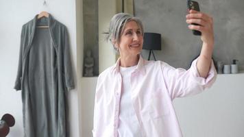 Woman at home taking selfie video