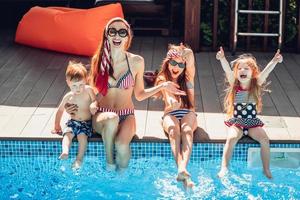 happy family having fun time at the pool side photo