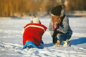 mother and daughter in winter outdoors photo