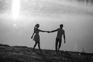 Couple in sunrise on the beach photo