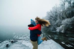 beautiful couple having fun on the pier photo