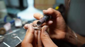 girl master processes the metal plate in the home workshop photo