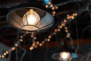 Lamp hanging outside on a dark background. photo