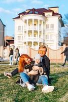 happy mom dad and son hugging in the park photo