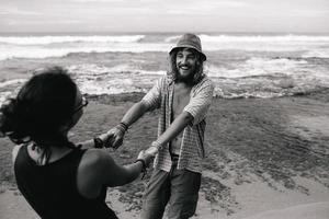 guy and girl have fun on the beach photo