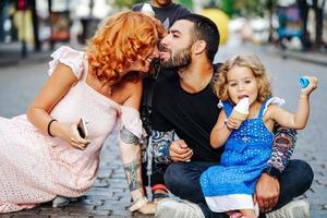 beautiful young family with ice cream photo