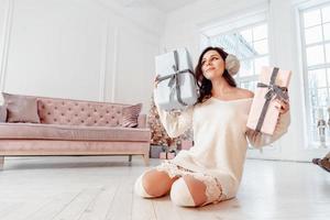 Beautiful young girl in white dress posing on camera. Christmas concept photo