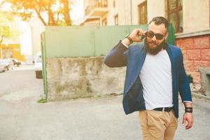 Bearded businessman looking at phone photo