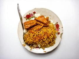 Fried noodles with fried rice and tempeh photo