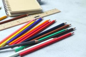 Wooden crayons scattered on the table, wooden rulers and notebooks with the festival back to the semester, students go to school, art lessons. photo