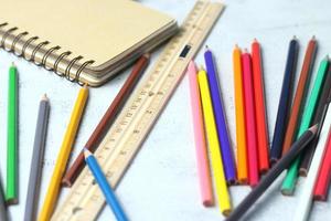 Wooden crayons scattered on the table, wooden rulers and notebooks with the festival back to the semester, students go to school, art lessons. photo