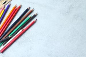 Wooden crayons scattered on the table, wooden rulers and notebooks with the festival back to the semester, students go to school, art lessons. photo