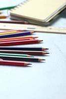 Wooden crayons scattered on the table, wooden rulers and notebooks with the festival back to the semester, students go to school, art lessons. photo