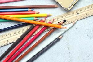 Wooden crayons scattered on the table, wooden rulers and notebooks with the festival back to the semester, students go to school, art lessons. photo