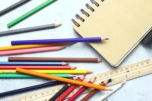 Wooden crayons scattered on the table, wooden rulers and notebooks with the festival back to the semester, students go to school, art lessons. photo