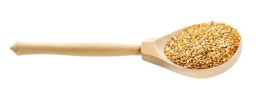 wooden spoon with golden flax seeds isolated photo