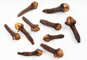 several whole dried cloves close up on gray photo