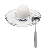 whole boiled white egg and spoon in glass egg cup photo