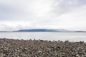 playa de guijarros con pirámides de piedra en reykjavik foto