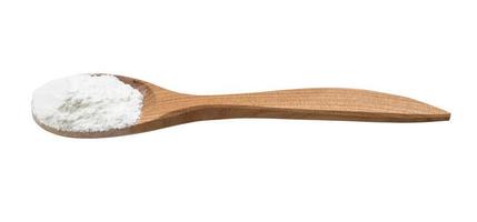 baking powder in wooden spoon isolated photo