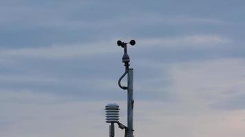 Weather station for measuring wind velocity. Anemometer on blue sky with clouds. Monitor weather. Precision farming equipment video