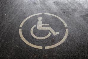 Parking spaces for disabled customers. Parking lot with painted sign of wheelchair. photo