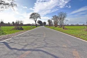 Beautiful view on countryside roads with fields and trees in northern europe photo