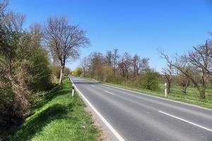 Beautiful view on countryside roads with fields and trees in northern europe photo