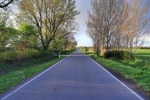 Beautiful view on countryside roads with fields and trees in northern europe photo