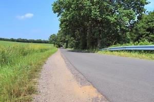 Beautiful view on countryside roads with fields and trees in northern europe photo