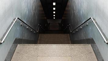 Looking down passageway stairs to subway station photo