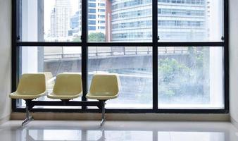 Yellow lobby waiting chair with building view background and copy space photo