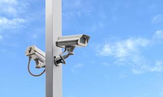 Outdoor white CCTV on pole with blue sky background and copy space photo