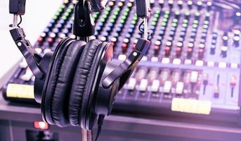The headphone on tripod with mixer background in sound control room. photo