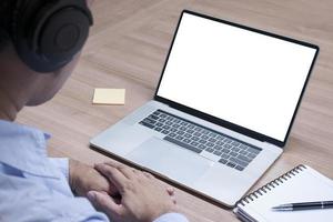 Businessman hands clasped together and white screen background mock up on display laptop with clipping path photo