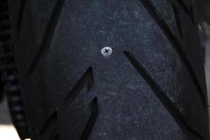 Motorcycle tire leaks due to nail photo