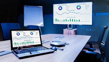 Mock up chart slide show presentation on display television and laptop in meeting room photo