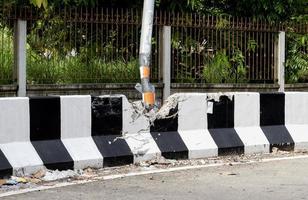Electric poles and barrier broken by car crash. photo