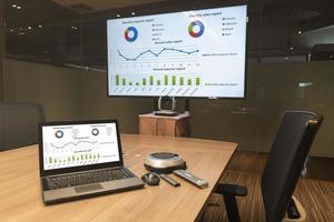 Mock up chart diagram presentation on display laptop and television in meeting room photo