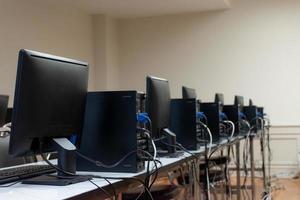 Computer lined up in computer classroom photo