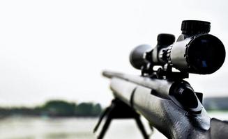 Rifle with a scope and bipod with first person shooter photo