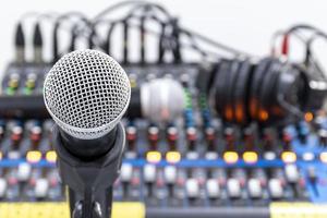 The microphone on tripod with mixer background in sound control room. photo