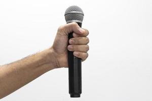 Hand holding microphone on white background photo