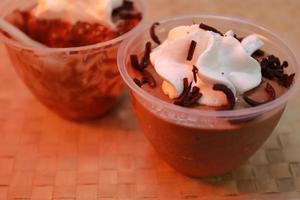 Tasty chocolate mousse decorated with whipping cream which is a perfect dessert for your party photo