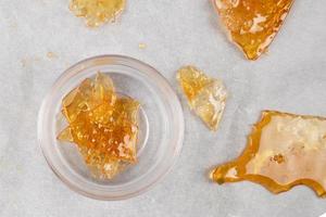 box with golden cannabis wax pieces, shatter resin photo