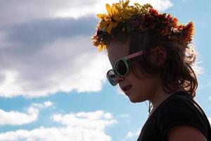 face girl 5 years old in black sunglasses against the sky,summer time concept copy space photo