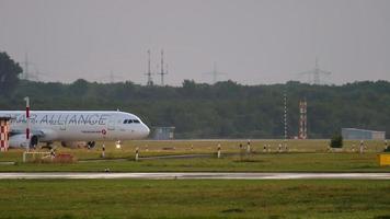 DUSSELDORF, GERMANY JULY 23, 2017 - Turkish Airlines Airbus A321 TC JRL in Star Alliance livery taxiing after landing, slow motion. Dusseldorf airport video